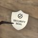 "SECURITY SEAL" VOID nyomot hagyó biztonsági matrica 25x30 mm pajzs forma, matt ezüst