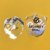 "SECURITY SEAL" VOID nyomot hagyó biztonsági matrica 25x30 mm pajzs forma, matt ezüst
