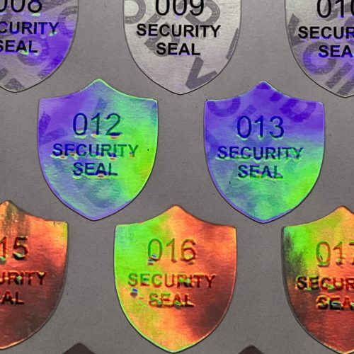 "SECURITY SEAL" VOID nyomot hagyó biztonsági matrica 25x30 mm pajzs forma, matt ezüst