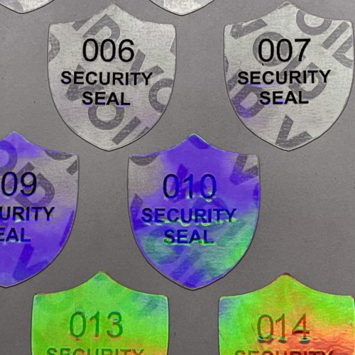 "SECURITY SEAL" VOID nyomot hagyó biztonsági matrica 25x30 mm pajzs forma, matt ezüst