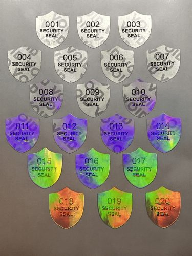 "SECURITY SEAL" VOID nyomot hagyó biztonsági matrica 25x30 mm pajzs forma, matt ezüst