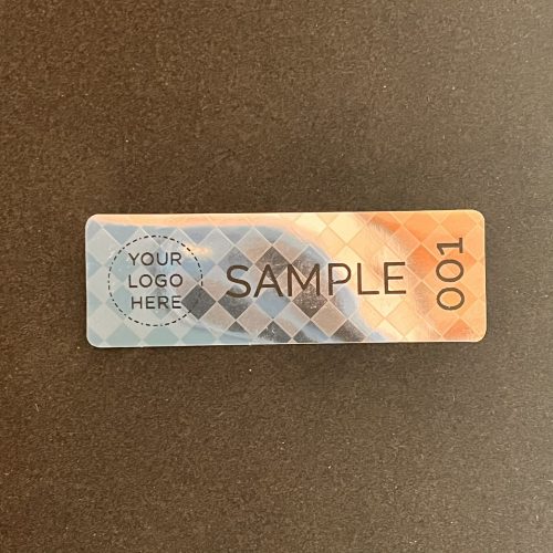 Pepita nyomot hagyó biztonsági matrica 60x20 mm fekete EGYEDI nyomtatással, matt ezüst