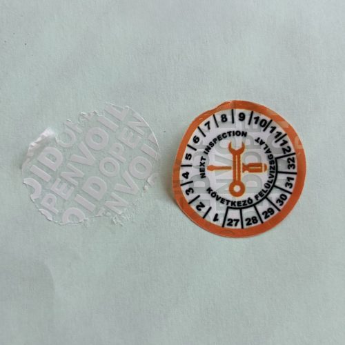 VOID nyomot hagyó 6 éves (2027-2032) felülvizsgálati biztonsági matrica narancs/fekete nyomtatással, 30 mm kör, matt fehér