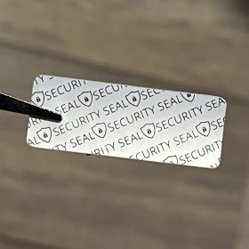   "SECURITY SEAL" VOID nyomot hagyó biztonsági matrica 40x15 mm, matt ezüst